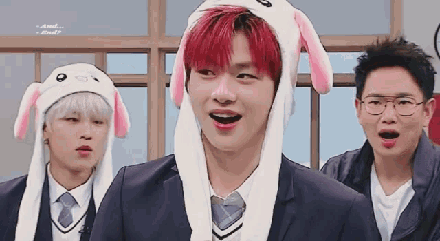 a boy with red hair wearing a bunny hat