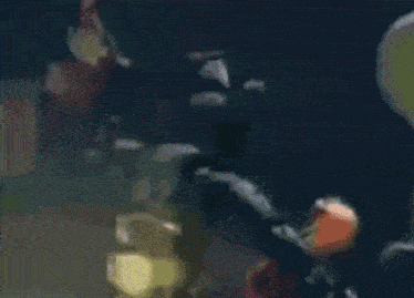 a blurry picture of a person holding a sword in the dark