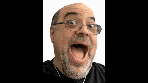a close up of a man 's face with his mouth open