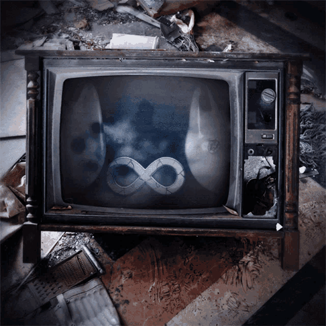 a broken television with a picture of an infinity symbol on it
