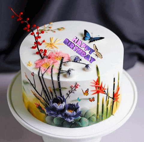 a birthday cake decorated with butterflies and flowers and the words happy birthday