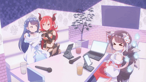 a group of anime girls sitting around a table with a laptop