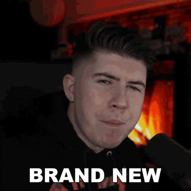 a man is singing into a microphone with the words brand new written below him