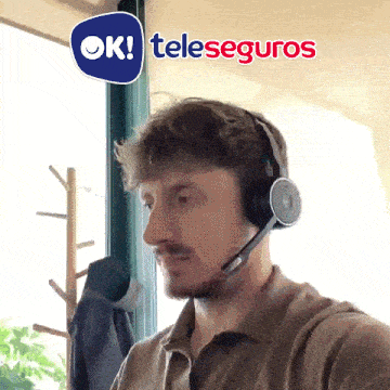 a man wearing a headset with a teleseguros logo on the bottom