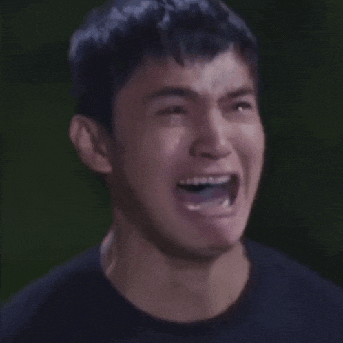 a close up of a man 's face with his mouth open