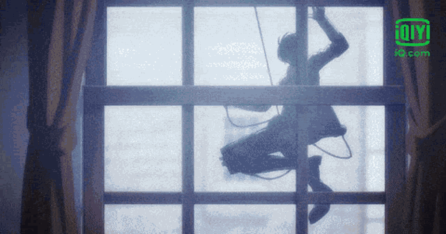 a silhouette of a person hanging from a rope in front of a window with an ig.com logo on the bottom right