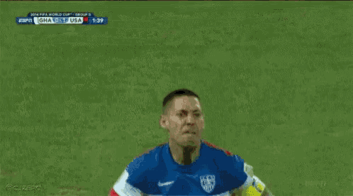 a soccer player in a red white and blue jersey is standing on a field