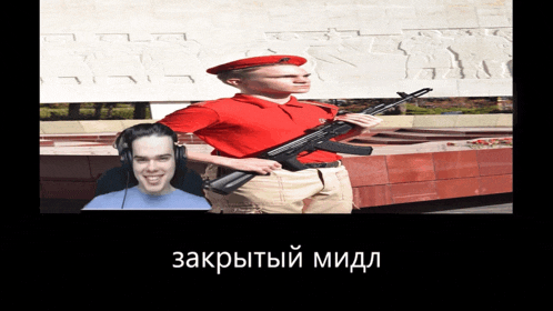 a man in a red shirt is holding a gun next to another man with headphones