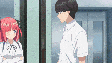 a man and a girl are standing next to each other in a room .