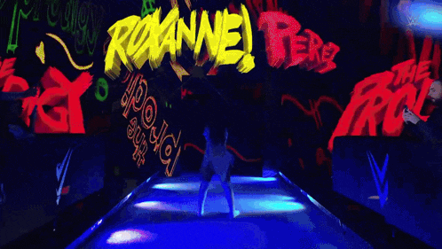 a woman is walking down a runway in front of a roxanne perez sign