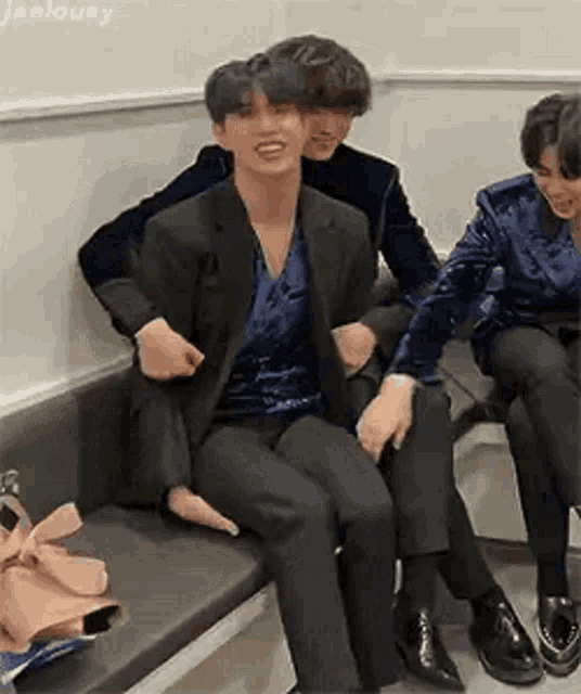 a group of men are sitting on a couch .