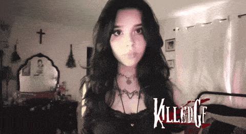 a woman stands in front of a sign that says killed gf