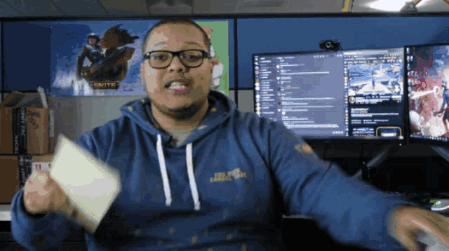 a man wearing a blue sweatshirt that says smite on the front