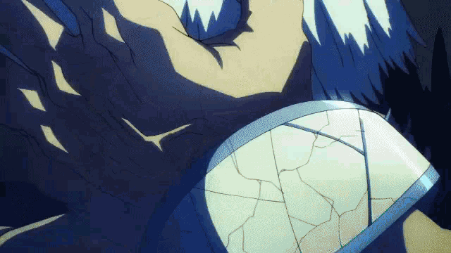 a close up of a person 's shoulder with a cracked shield