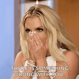 a woman is covering her face with her hands and saying `` there is something wrong with you '' .