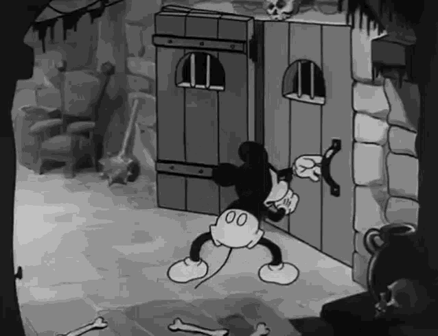 a black and white cartoon of mickey mouse is standing in front of a door