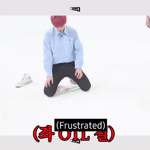 a man with red hair is kneeling on the floor with the word frustrated written above him