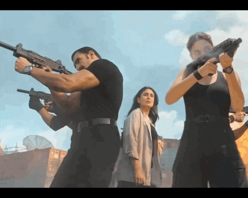 a group of people are holding guns in a line