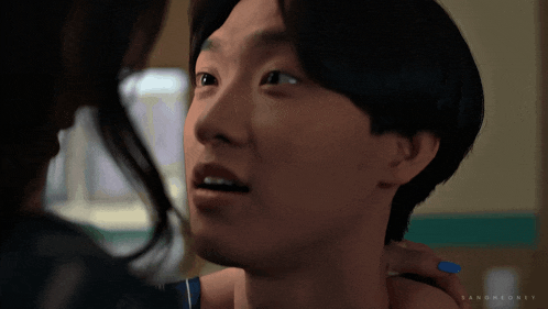 a close up of a man 's face with a woman 's hand on his shoulder and the word bang on it