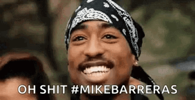 a man wearing a bandana and a hat is smiling and saying `` oh shit # mikebarrieras '' .