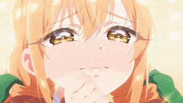a close up of a girl 's face with her hand on her chin