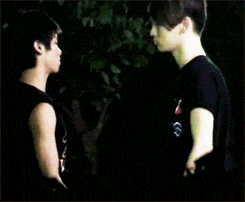 a man in a black shirt is standing next to a woman in a black shirt