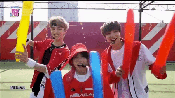 a group of young men are standing next to each other on a court holding balloons .