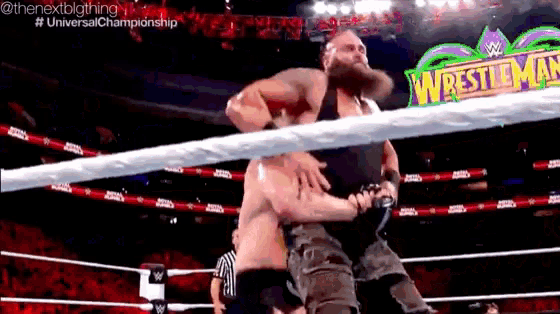 two men are wrestling in a ring with a sign that says wrestlemania .