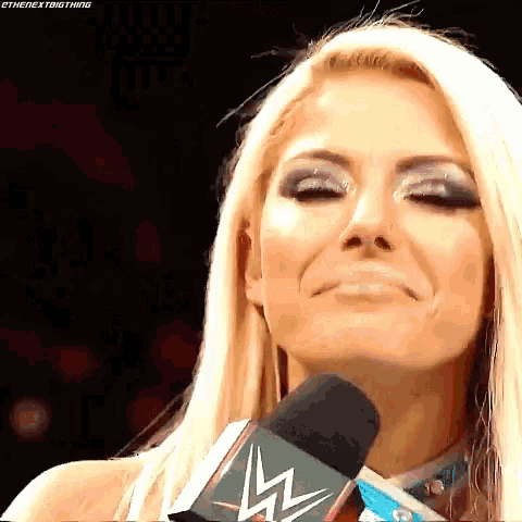 a close up of a woman talking into a microphone .