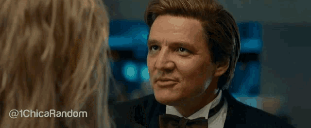 a woman with blonde hair is making a funny face while looking at a man in a suit .