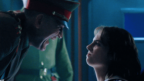 a man in a military uniform is screaming at a woman