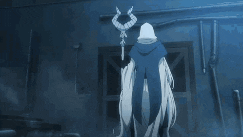 a person with a hood on their head in a dark room .