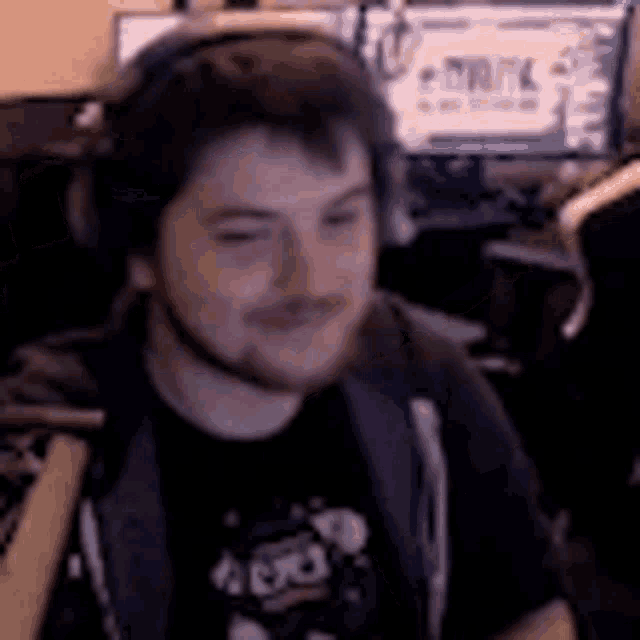 a man wearing headphones and a shirt that says army