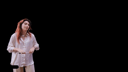 a woman is pointing at a flag with a stick