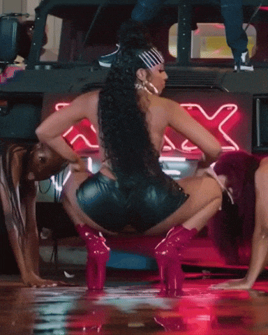 a woman in a green bikini is squatting down in front of a neon sign that says sassy