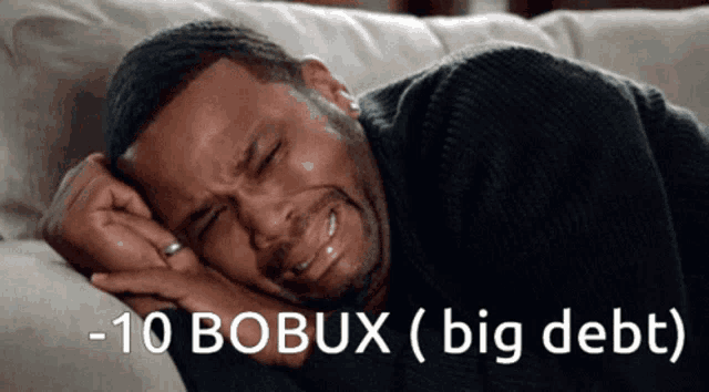 a man is crying while laying on a couch with the words -10 bobux ( big debt ) written below him