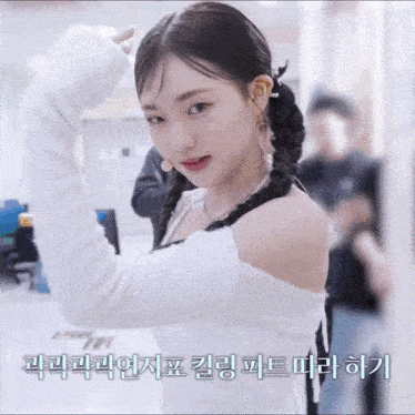 a woman in a white off the shoulder top with foreign writing