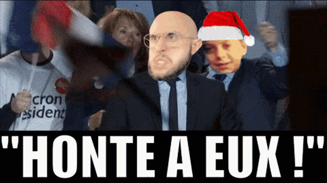 a man wearing a santa hat stands in front of a crowd with the words honte a eux written on the bottom