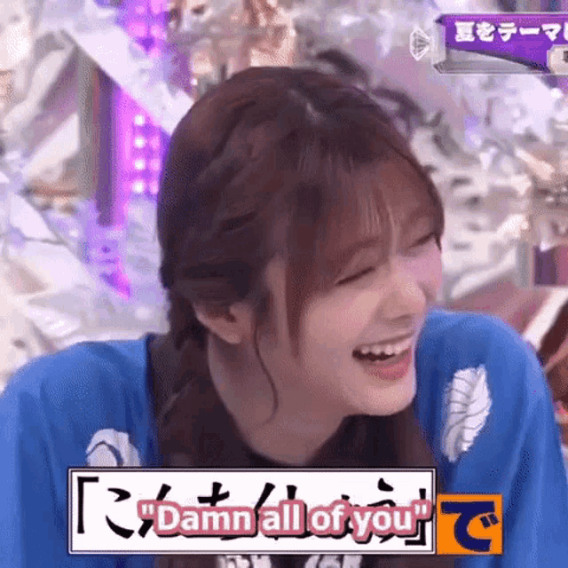 a girl is laughing and saying `` damn all of you '' while wearing a blue shirt .