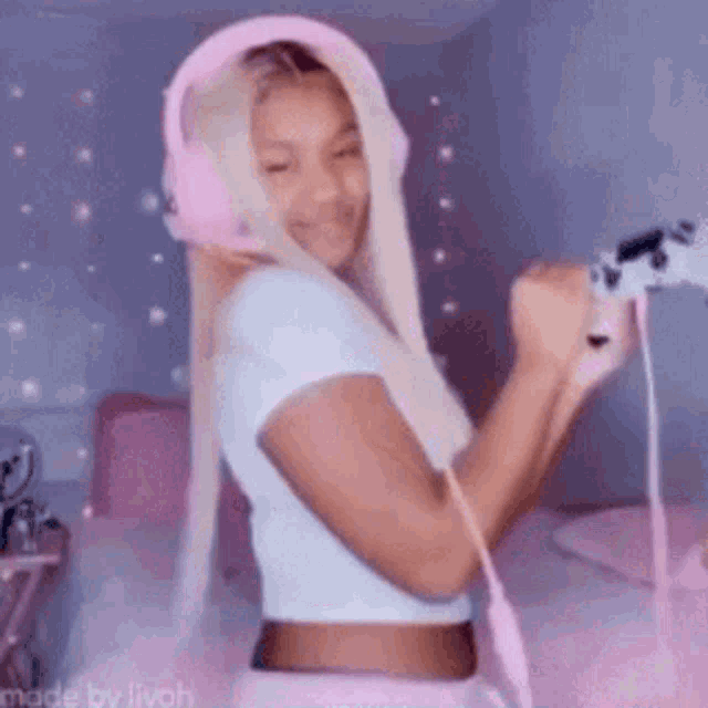 a woman wearing pink headphones and holding a video game controller is playing a video game .