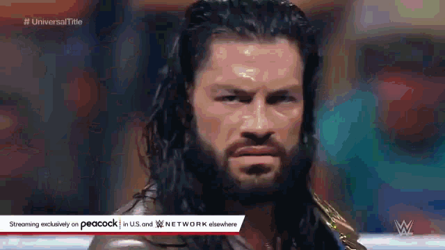 roman reigns is a wrestler with a beard and a championship belt on his shoulder .