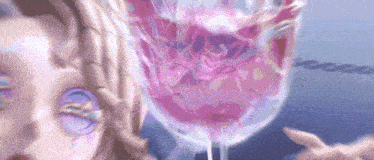 a woman with purple eyes is standing next to a glass of pink liquid
