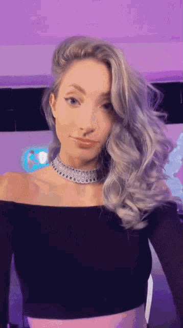 a woman with gray hair wearing a choker and a black off the shoulder top