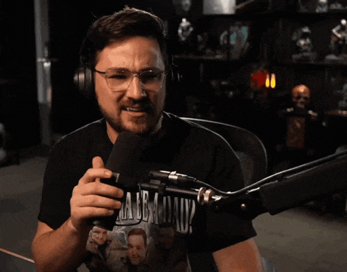 a man wearing headphones and a t-shirt that says ' what ' on it