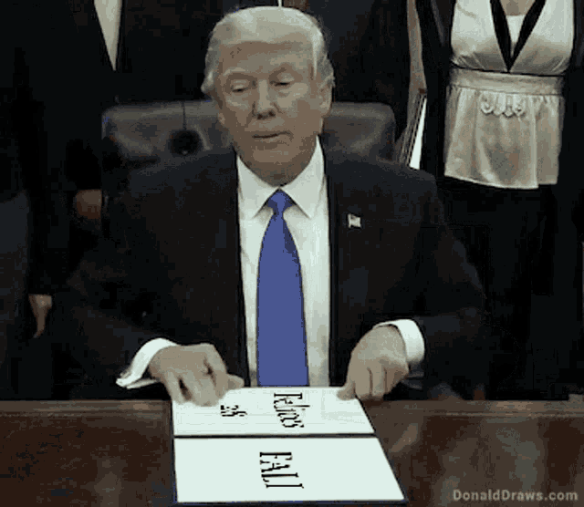 donald trump is sitting at a desk with a sign that says " felixs fail "