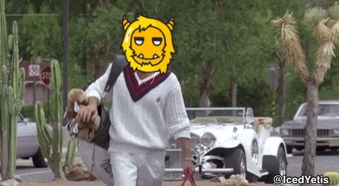 a man carrying a dog in a sweater with a yellow monster on his face