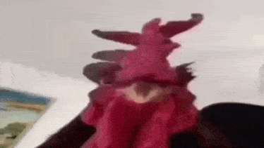 a close up of a rooster 's head with a red feather on it 's head .