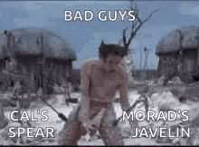 a man without a shirt is standing in the snow holding a spear and a spear .
