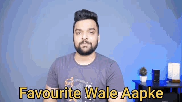 a man with a beard is wearing a t-shirt that says " favourite wale aapke "