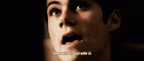 a close up of a young man 's face with the words `` start with f , end with u '' written on it .